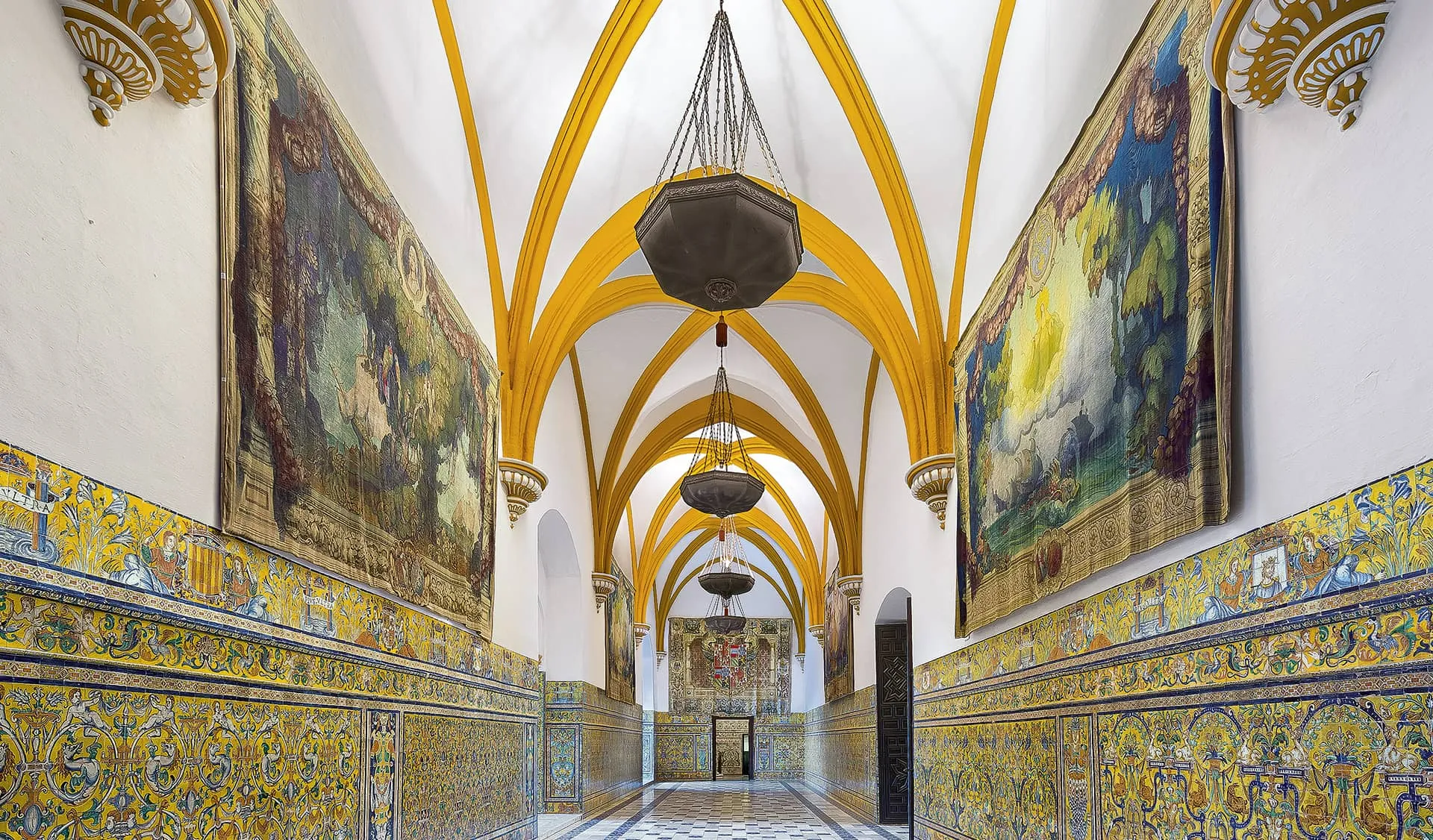 Arched hall with ribbed vaults and ambient light inside the Alcázar